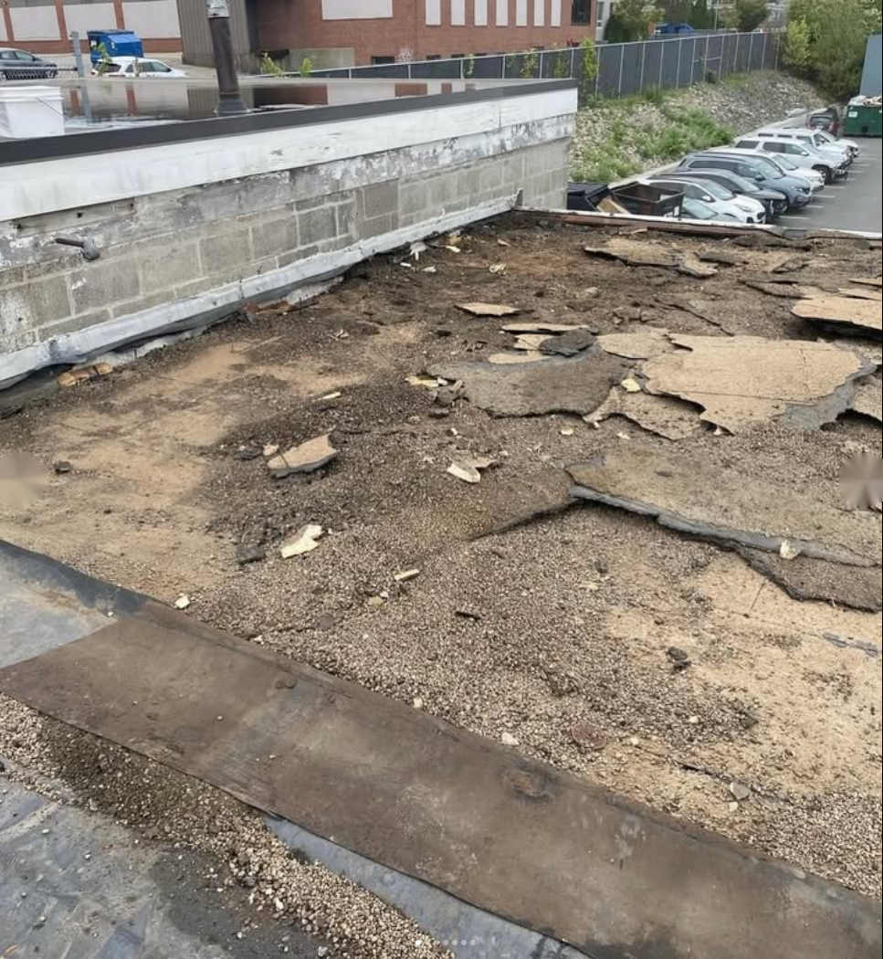 Commercial roof surface being evaluated for repair