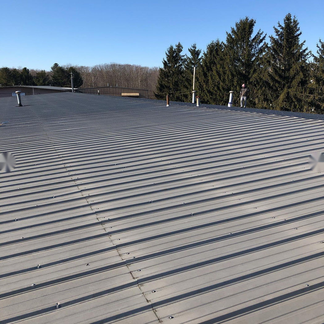 Massachusetts Commercial Roofing crew on a finished roof project